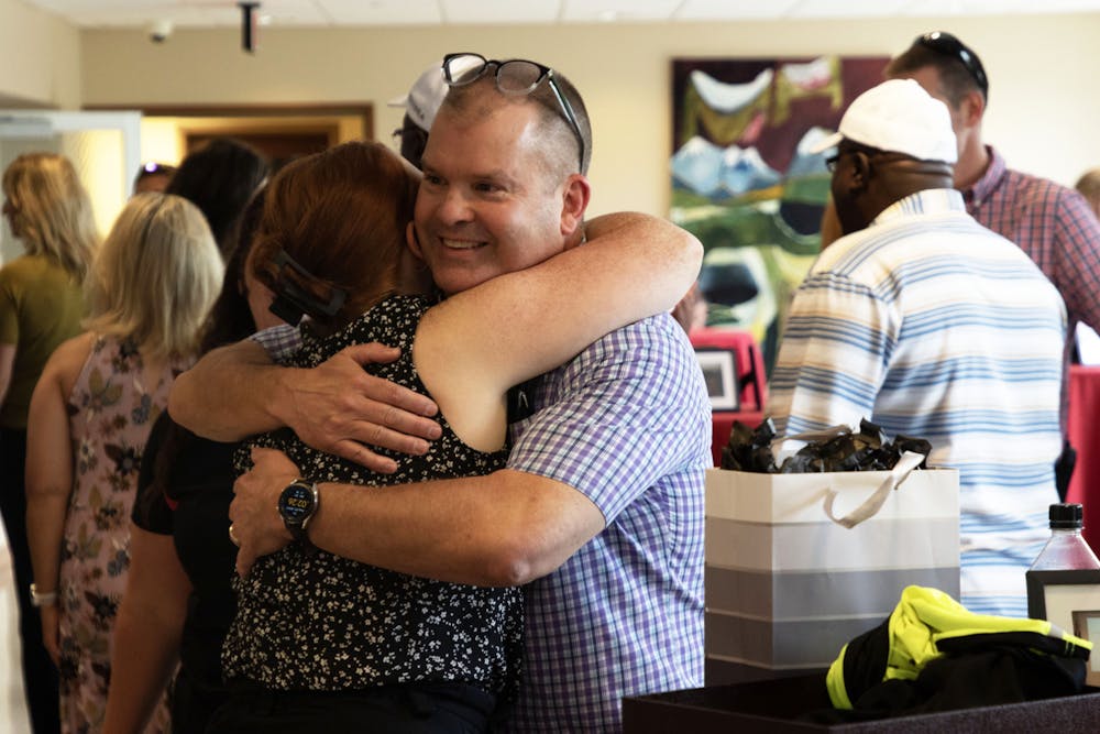 <p>Chief Jim Duckham hugs a guest at his retirement party Aug. 25 at the L.A. Pittenger Student Center. Chief Duckham's last day is Aug. 31. Olivia Ground, DN</p>