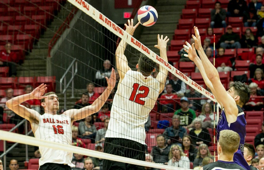 Sophomore setter Jake Romano sets the ball to senior outside attacker Matt Walsh during the MIVA Tournament Quarterfinals against McKendree April 14 in John E. Worthen Arena. Romano had 36 assists throughout the sets. Kaiti Sullivan, DN