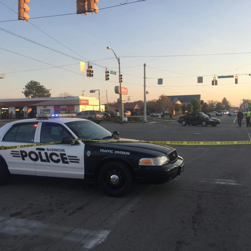 <p>A Muncie police car blocks traffic at the intersection of McGalliard Road and Oakwood Avenue after a fatal crash&nbsp;occurred&nbsp;on Nov. 15.&nbsp;An elderly woman died after being fatally struck in the car accident.&nbsp;<i style="background-color: initial;">Max Lewis // DN</i></p>