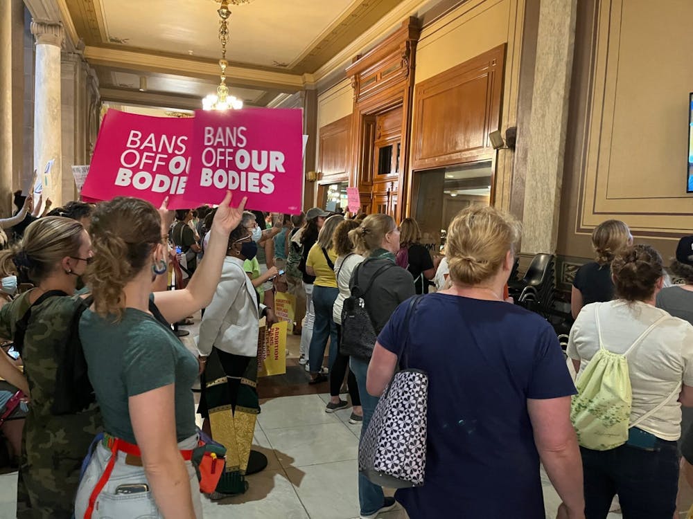 A group of protestors stand in the Indiana Statehouse in Indianapolis, Indiana, holding signs that read "Bans off our bodies". SB 1 is scheduled to be made official Sept. 15, banning abortions in Indiana almost completely. 