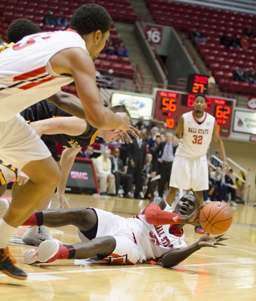 Senior center Majok Majok looks to freshman forward Franko House to pass the ball during the second half against Toledo Feb. 8 at Worthen Arena. DN PHOTO BREANNA DAUGHERTY 