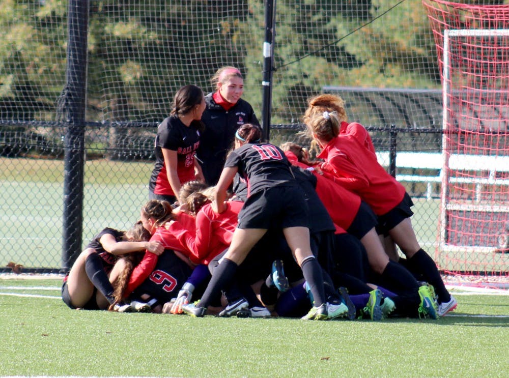 The Ball State Women's Soccer Team tackles and piles on their teammate after the winning goal in the match against Buffalo on Oct. 25 at the Briner Sports Complex. DN PHOTO ALLYE CLAYTON