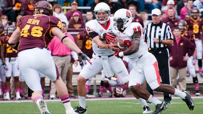 DN FILE PHOTO BOBBY ELLIS Quarterback Keith Wenning hands of to junior running back Barrington Scott in the match against Central Michigan on Oct. 20. The Cardinals will face off against Toledo tonight at Toledo.