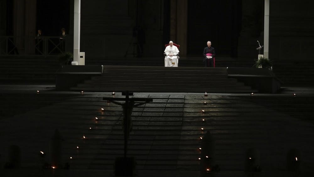 Pope Francis is flanked by Mons. Guido Marini, right, the Vatican master of liturgical ceremonies, as he leads the Via Crucis – or Way of the Cross – ceremony in St. Peter's Square empty of the faithful following Italy's ban on gatherings to contain coronavirus contagion, at the Vatican, Friday, April 10, 2020. (AP Photo/Alessandra Tarantino)