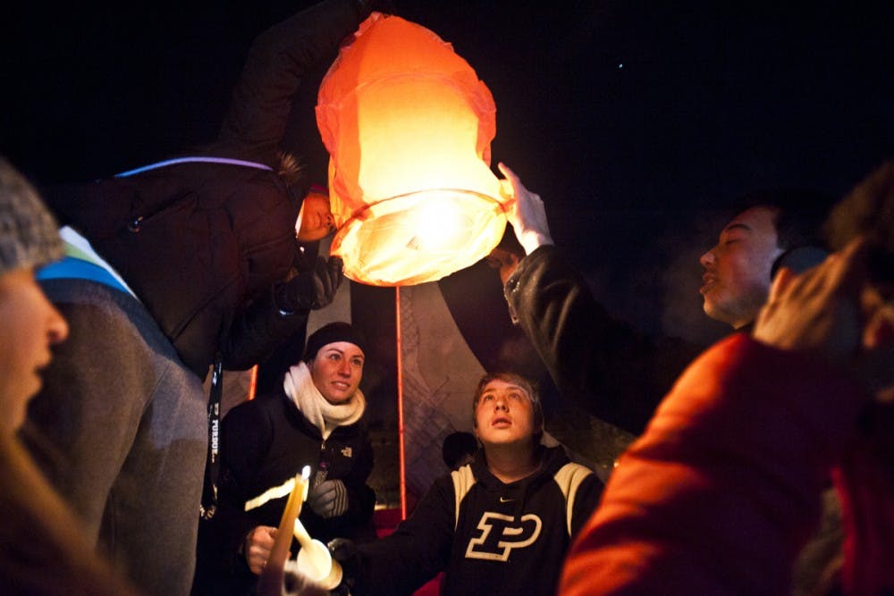 A group of students attempt to light a Chinese lantern at the conclusion of the vigil Tuesday night in front of Hovde Hall at Purdue University held after the death of Andrew Boldt. PHOTO PROVIDED PURDUEEXPONENT.ORG