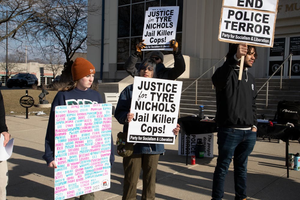 Protesters chant outside Muncie City Hall in “Unite Against Police Brutality” protest.