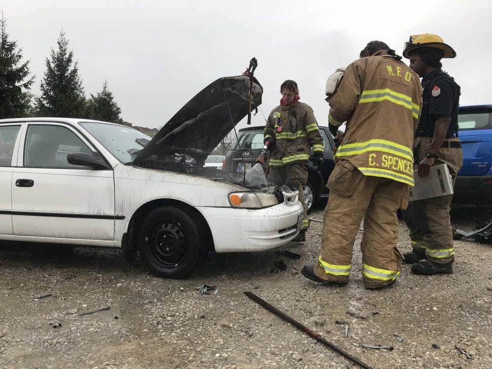 Muncie Fire Department responds to a car fire in the Village at the corner of McKinley and University avenues on Friday, Sept. 7, 2018. David Pankow, 22, owner of the car said he was driving when the car started smoking. Mary Freda, DN