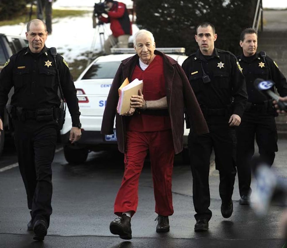 Jerry Sandusky is escorted to the Centre County Courthouse in Bellefonte, Pennsylvania, for a hearing on Thursday, January 10, 2013. (Nabil K. Mark/Centre Daily Times/MCT)