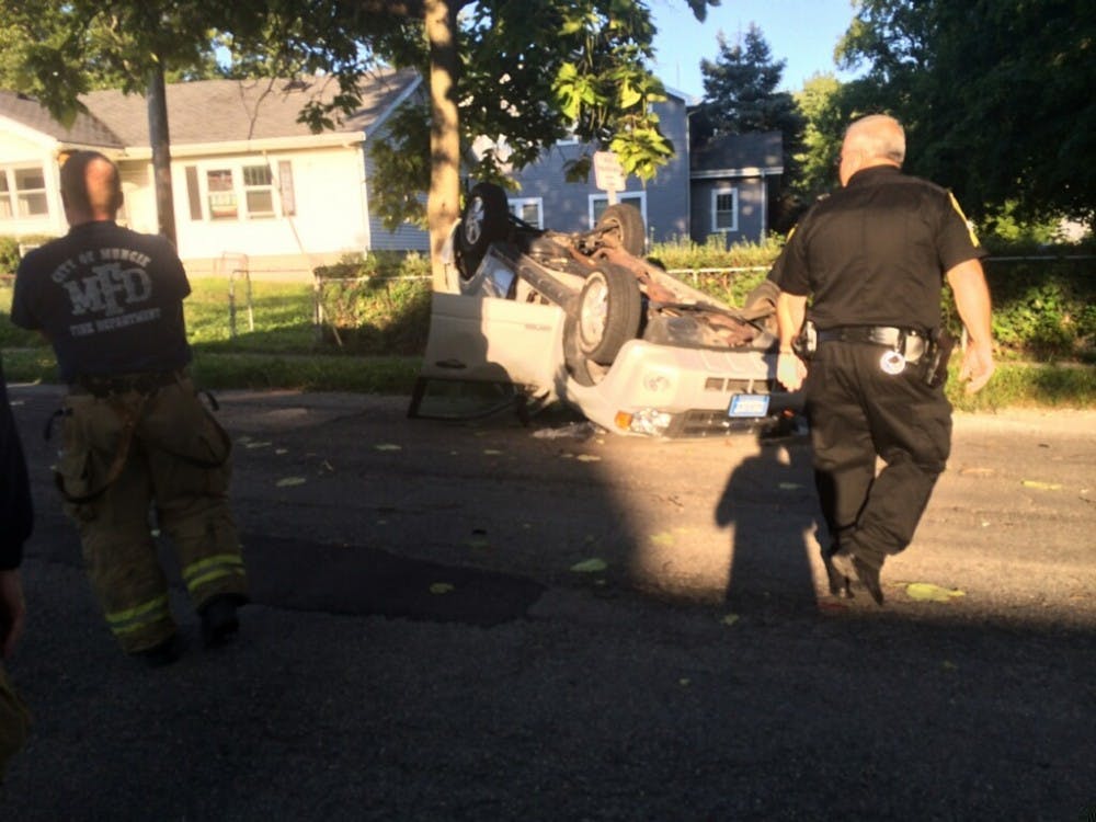 A Ford Escape lays upside down after a collision at the intersection of  Riverside and Beechwood streets. The driver was taken to Ball Memorial  Hospital with minor injuries, the other driver was uninjured. DN PHOTO CHRISTOPHER STEPHENS