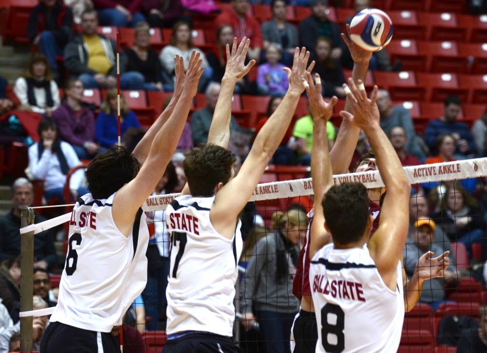 Members of the men's volleyball team attempt to block a hit from Harvard during the match on Jan. 15 at Worthen Arena. DN PHOTO EMMA ROGERS