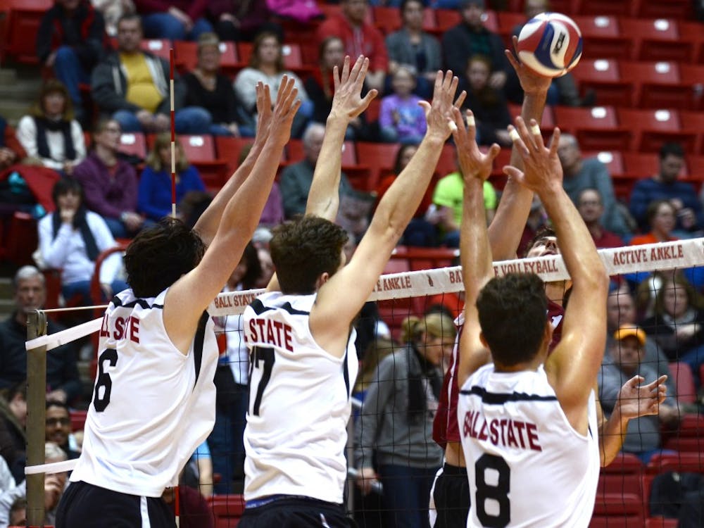 Members of the men's volleyball team attempt to block a hit from Harvard during the match on Jan. 15 at Worthen Arena. DN PHOTO EMMA ROGERS