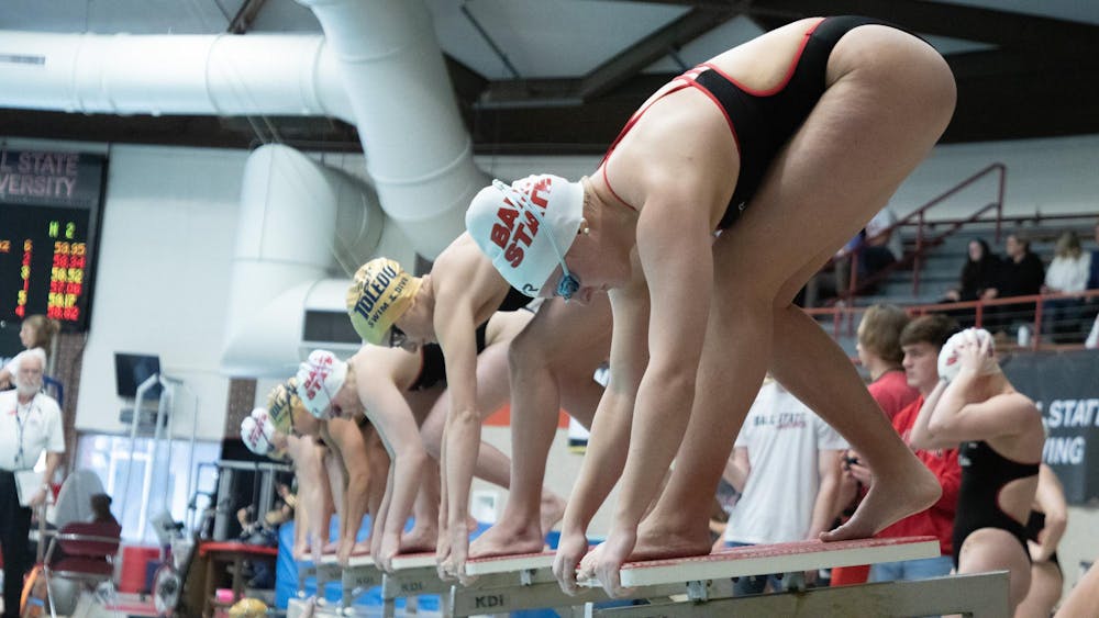 Junior Neely Agnew, Junior Eliza Bader, and Senior Laura Wright preapres to launch off for 100 meters Breastroke at the meet against Toledo Jan. 20 at Lewellen Aquatic Center. Ball State Women's Swim won 182-117. Kate Tilbury, DN