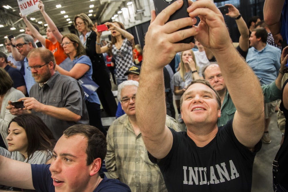 Taking a selfie just before Donald Trump's loud introduction at April 20 rally in Indianapolis. DN PHOTO/TRENT SCROGGINS