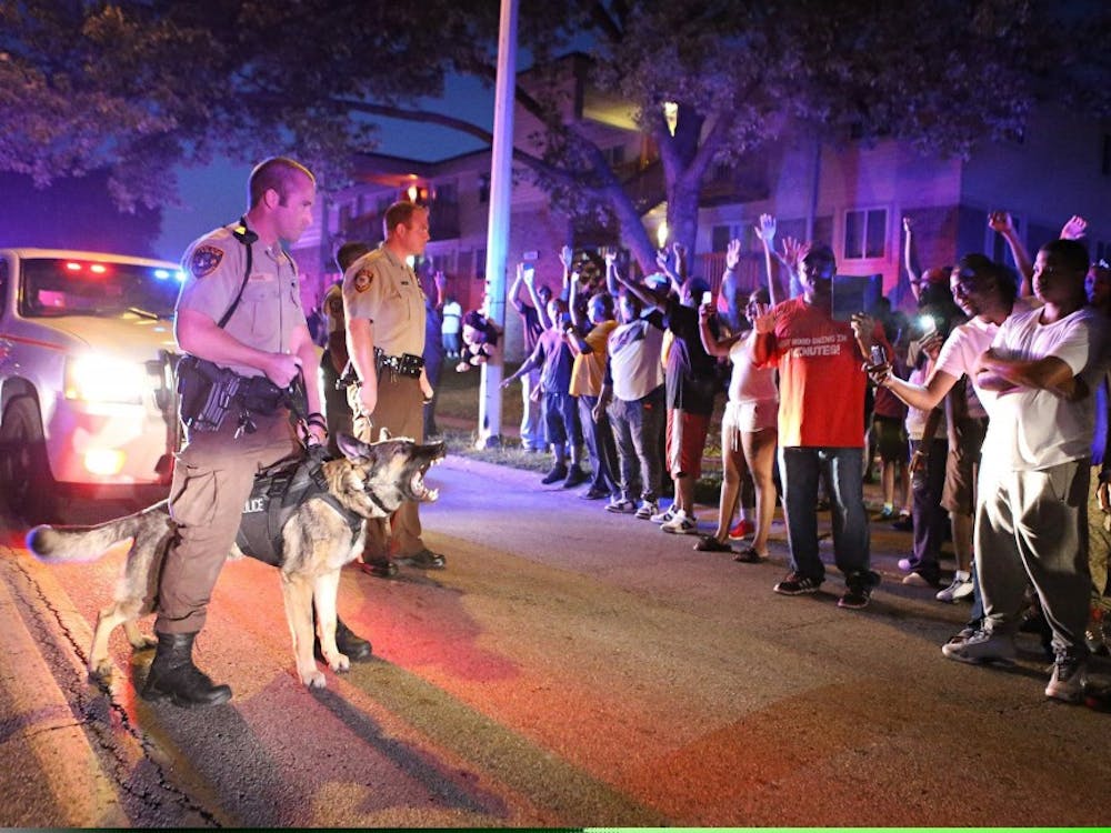 Police officers stand to confront a crowd they're trying to break up a demonstration in Ferguson, Mo., on Saturday, Aug. 9, 2014. Earlier in the day police had shot and killed an 18-year-old man. (David Carson/St. Louis Post-Dispatch/MCT)