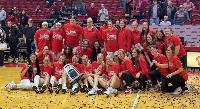 The 2024-25 Ball State women's basketball team poses with the Mid-American Conference (MAC) regular season trophy. The Cardinals won the title after defeating Buffalo 72-60. Elijah Poe, DN