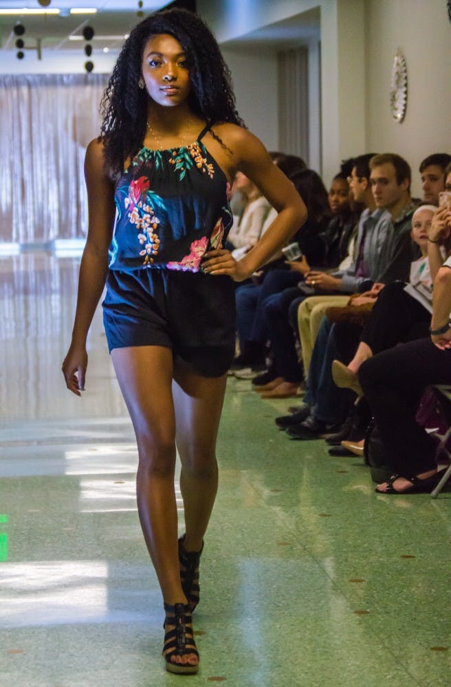 Family and friends watched the Fashion Design Soceity host a fashion show on April 1 in the Applied Technology Building. Since 1997, the organization helps fashion students develop their skills. Teri Lightning Jr., DN