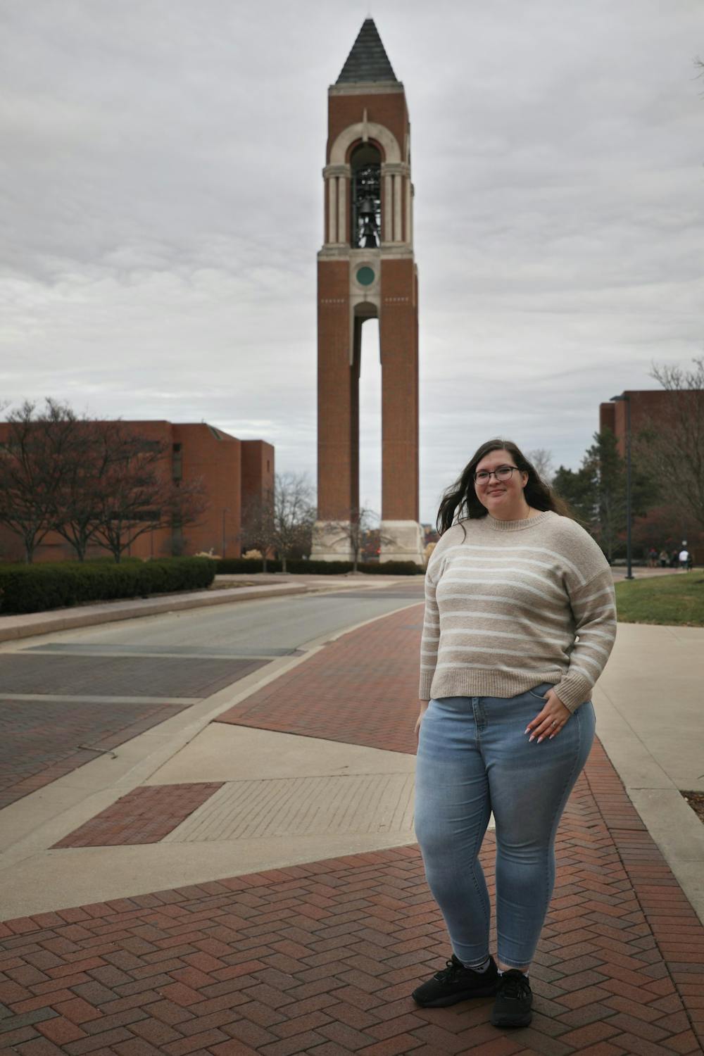 Graduating third-year Emily Moore poses for a portrait Dec. 2 in front of the bell tower at Ball State. Amber Pietz, DN