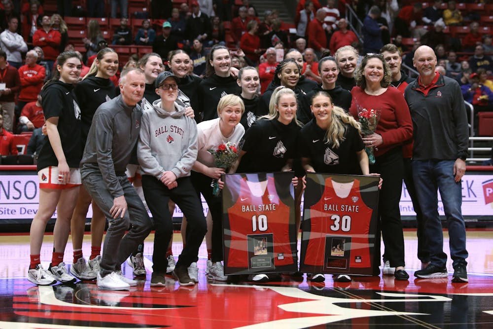 The Ball State Women's Basketball team poses for a photo with graduate student Thelma Dis Agustsdottir and redshirt-senior Anna Clephane for Senior Day before a game against Toledo Feb. 25 at Worthen Arena. Amber Pietz, DN