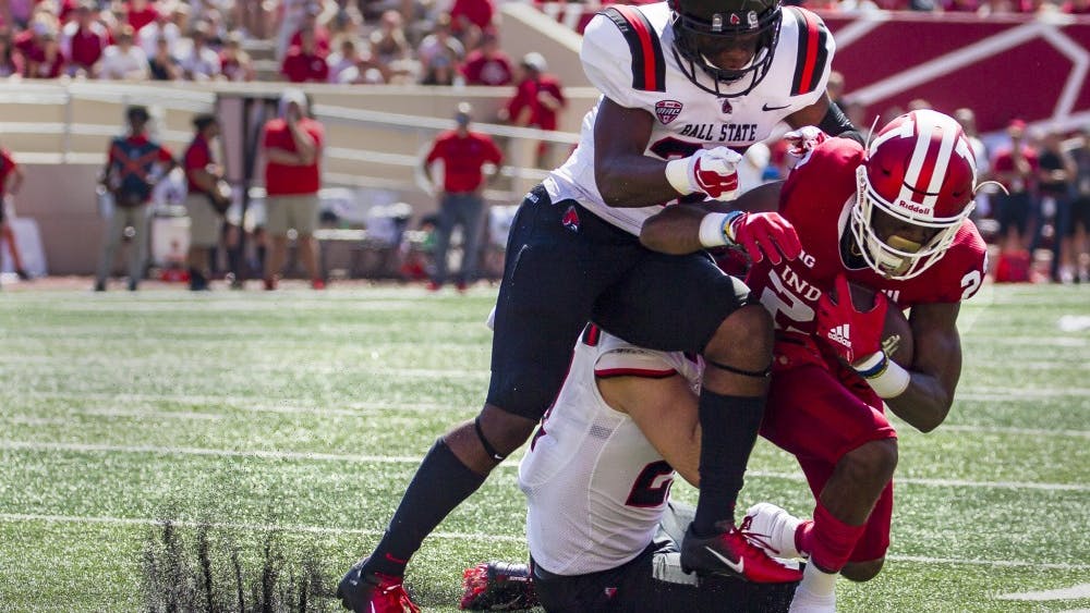 Sophomore wide receiver Whop Philter is tackled by junior safety Brett Anderson II and offensive line backer Jimmy Daw, Saturday, September 15, at Memorial Stadium, in Bloomington, IN. Ball State lost to IU, 10-38, making this their second loss of the season. Grace Hollars,DN