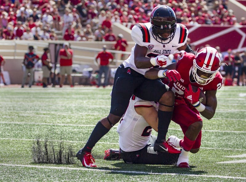 Sophomore wide receiver Whop Philter is tackled by junior safety Brett Anderson II and offensive line backer Jimmy Daw, Saturday, September 15, at Memorial Stadium, in Bloomington, IN. Ball State lost to IU, 10-38, making this their second loss of the season. Grace Hollars,DN