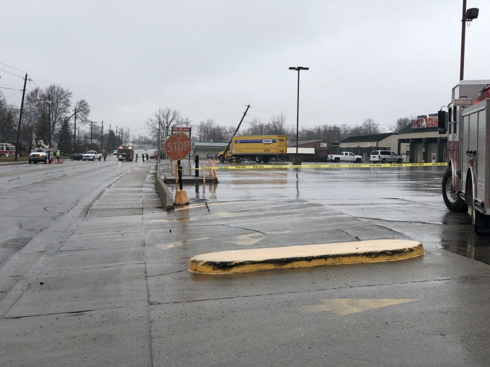 <p>A portion of North Walnut Street is closed after a Penske truck crashed into a utility pole Thursday, March 29, 2018. The accident occurred in the Family Dollar parking lot. <strong>Andrew Smith, DN Photo</strong></p>