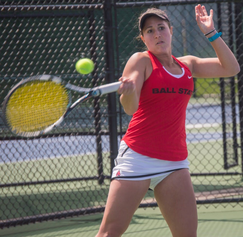 Senior Carmen Blanco hits the ball to the other side of the court during the match against Buffalo on April 2 at the Cardinal Creek Tennis Center. Blanco won her match 2-0. Teri Lightning Jr., DN
