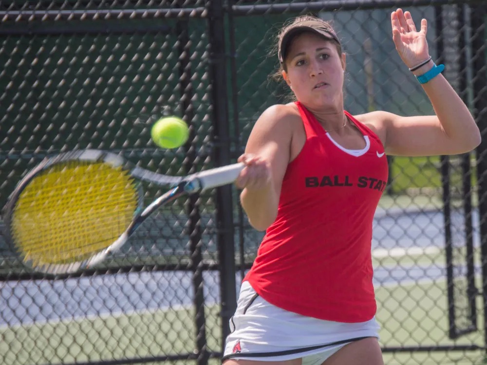 Senior Carmen Blanco hits the ball to the other side of the court during the match against Buffalo on April 2 at the Cardinal Creek Tennis Center. Blanco won her match 2-0. Teri Lightning Jr., DN