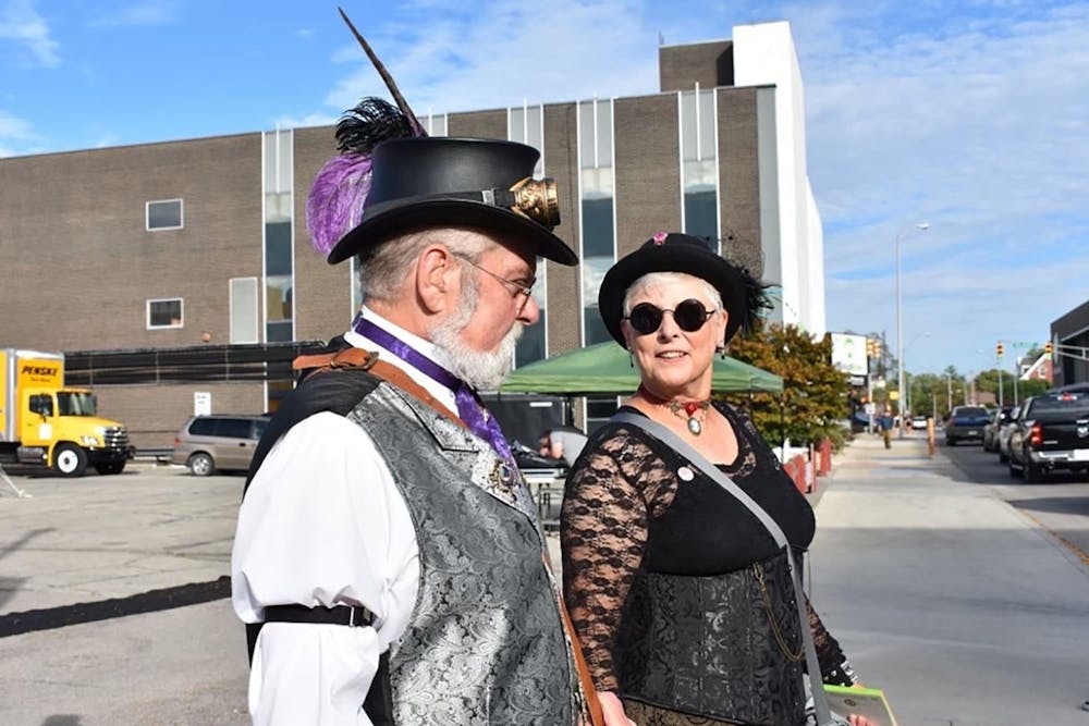 Jesse Creselious (left) and Cindy Britton (right) walk together down the streets of downtown  Muncie March 10, 2019. Their group, The Steampunk Consortium, attends events together such as YART, The Luminary Walk, group picnics and cemetery tours. Jessie Creselious, Photo Provided