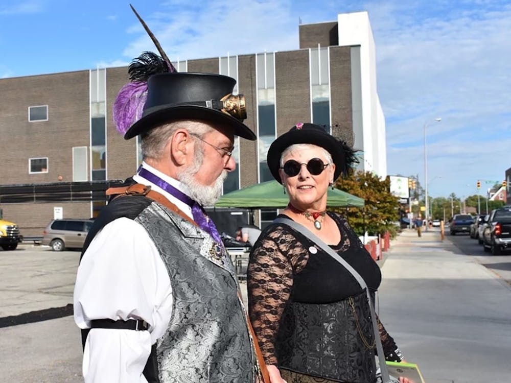 Jesse Creselious (left) and Cindy Britton (right) walk together down the streets of downtown  Muncie March 10, 2019. Their group, The Steampunk Consortium, attends events together such as YART, The Luminary Walk, group picnics and cemetery tours. Jessie Creselious, Photo Provided