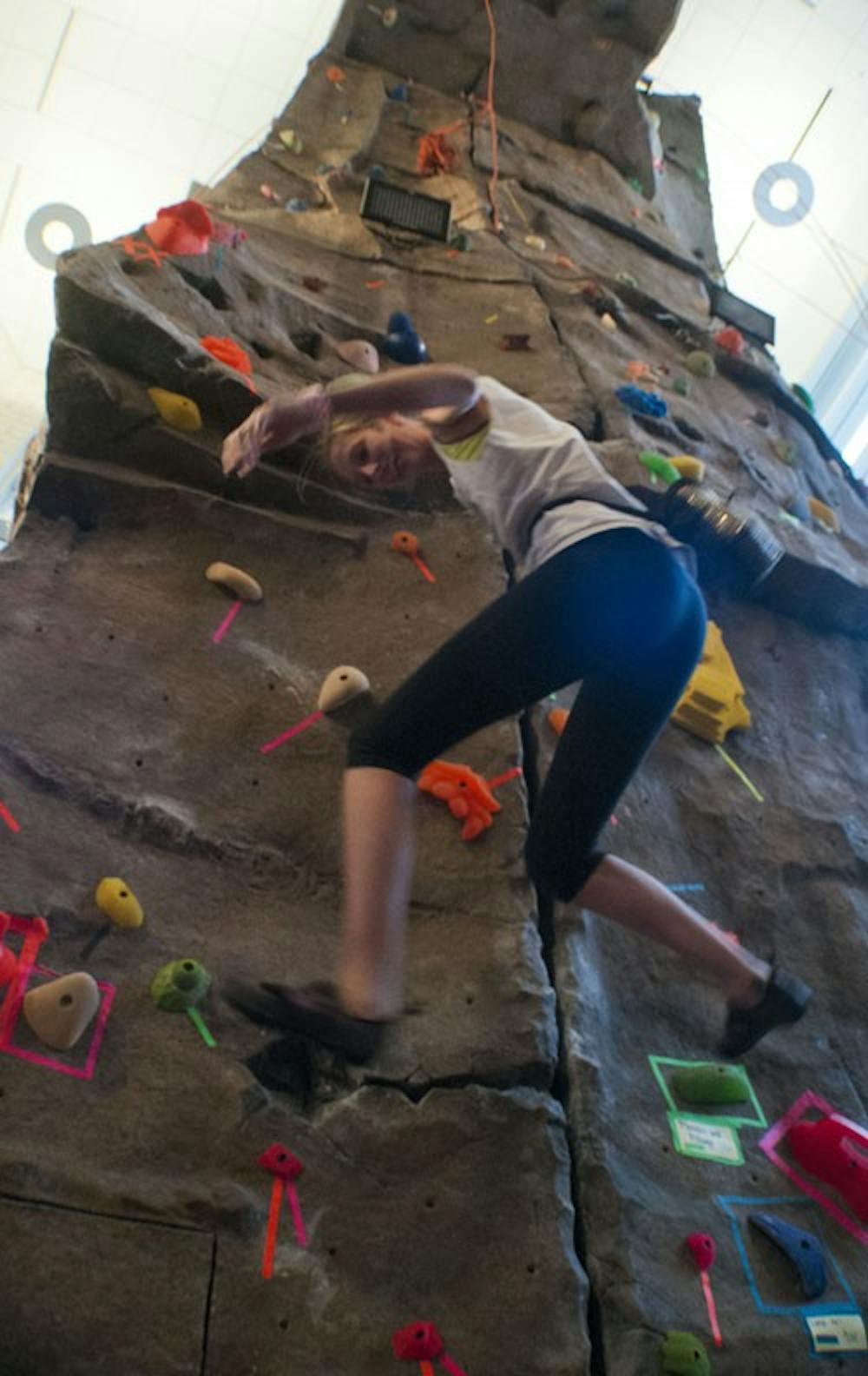 Earlham sophomore Saolie Rehm drops off the rock wall in the recreation center. DN PHOTO BOBBY ELLIS
