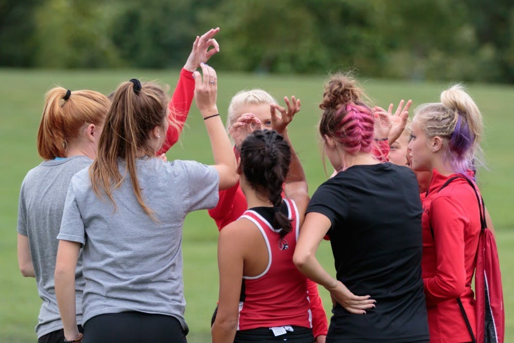 <p>Ball State Cross Country huddles up before the Butler Twilight meet at NorthView Church Sept. 1, 2017, in Carmel, Indiana. A select squad will be competing at the Indiana Intercollegiate Invite. <strong>Kyle Crawford, DN File</strong></p>