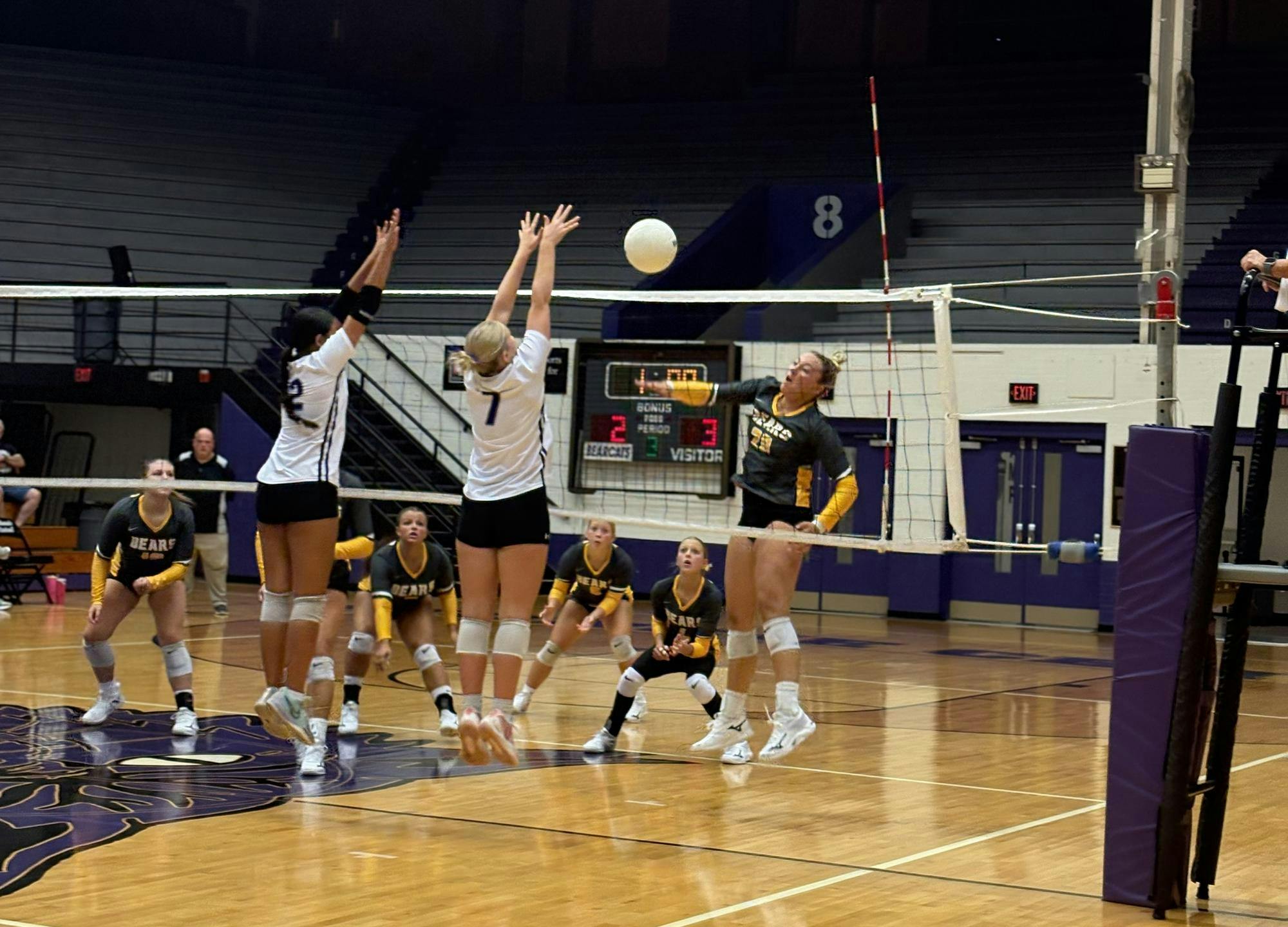 Seniors Kenli Mooneyham (left, #12) and Grace Walker (middle, #7) jump to block a spike made by the Monroe Central Bears. Muncie Central went 3-0 in straight sets to secure a home game victory on Sept. 11, 2025. PHOTO BY MADISON WARD.
