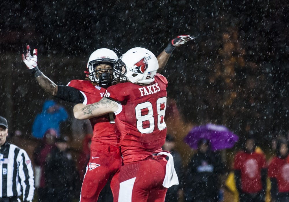 Senior wide receiver Jamill Smith is hoisted into the air by teammate Zane Fakes after scoring a touchdown against Central Michigan University on Nov. 6. Ball State won the game 44-24. DN PHOTO JONATHAN MIKSANEK