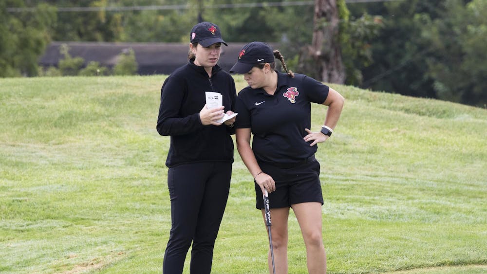 Senior Kiah Parrott studies her putt with graduate assistant Valeria Patino Sep. 18 during the Brittany Kelly Classic at The Players Club. Zach Carter, DN.