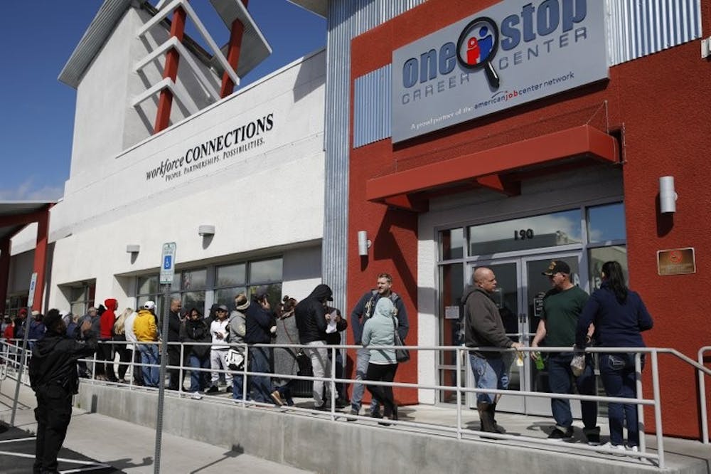 <p>In this March 17, 2020, file photo, people wait in line for help with unemployment benefits at the One-Stop Career Center in Las Vegas. A record-high number of people applied for unemployment benefits last week as layoffs engulfed the United States in the face of a near-total economic shutdown caused by the coronavirus. The surge in weekly applications for benefits far exceeded the previous record set in 1982. <strong>(AP Photo/John Locher, File)</strong></p>