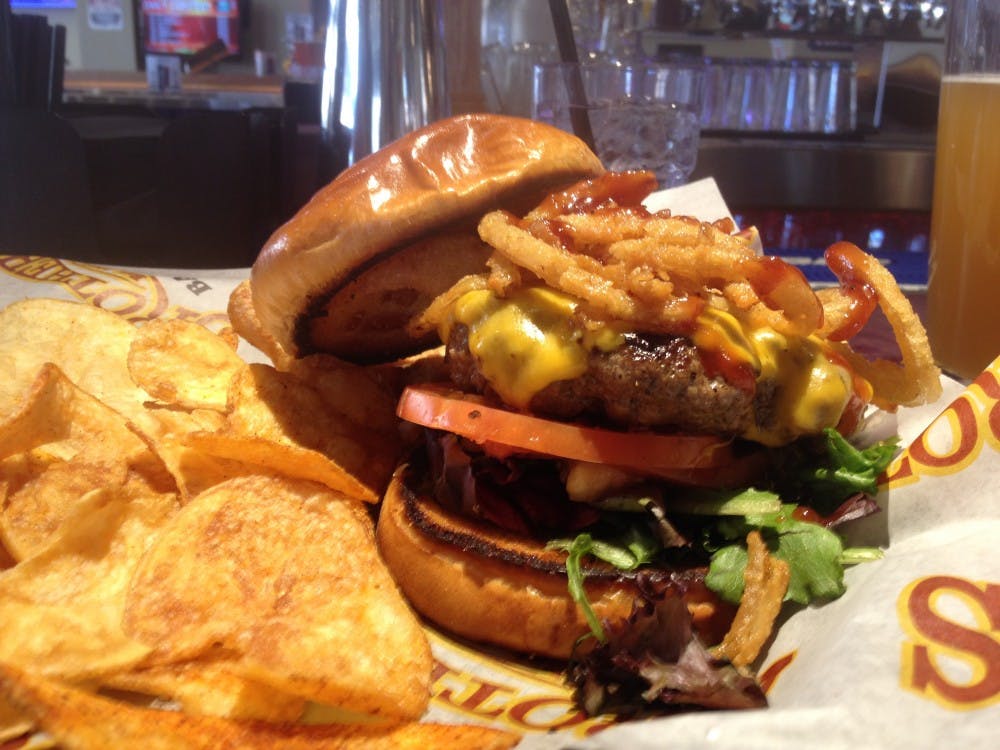 <p>The Stuffed Smokehouse Burger at Brothers in the Village. DN PHOTO ELLEN COLLIER</p>