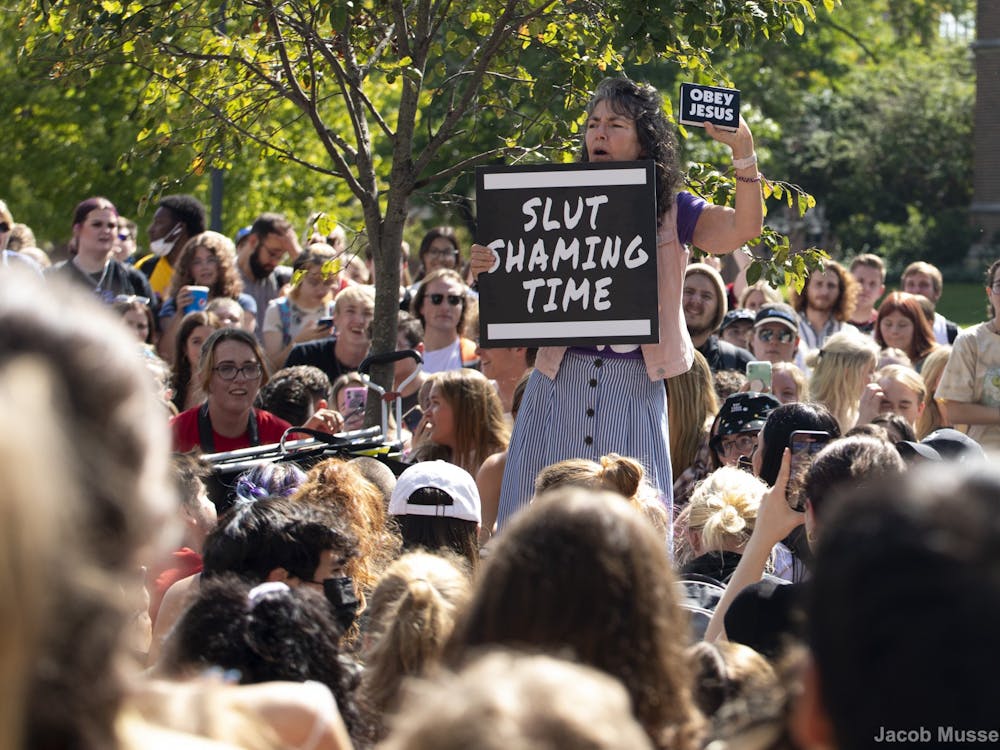 Cindy Smock, or “Sister Cindy” speaks to a crowd of students at her “Ho no mo” rally Sept. 17, 2021, at North Quad. Smock and her husband, “Brother Jed,” travel the country going to different colleges and preaching their beliefs. Jacob Musselman, DN