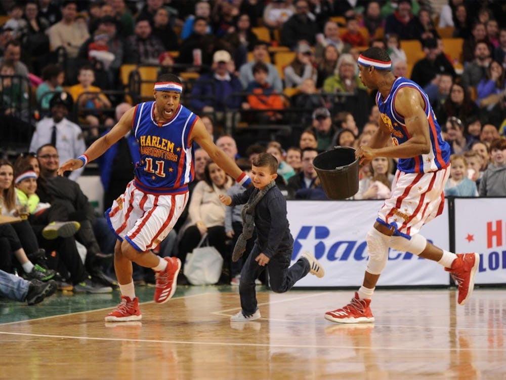 Brawley Chirshom, left, and a teammate chase an audience member around the court during a performance in Seattle. Harlem Globetrotters, Photo Provided