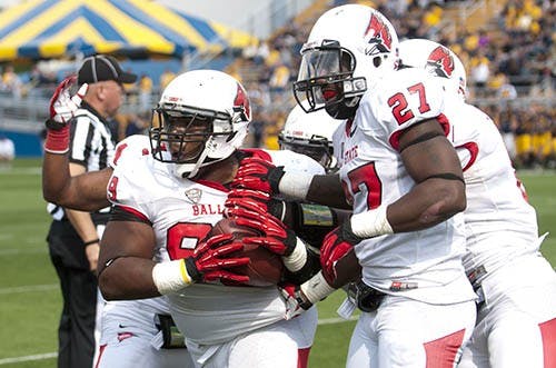Senior nose tackle Brandon Newman runs off the field after intercepting a tipped pass. Newman was one of several players who worked out in front of NFL scouts during Ball State