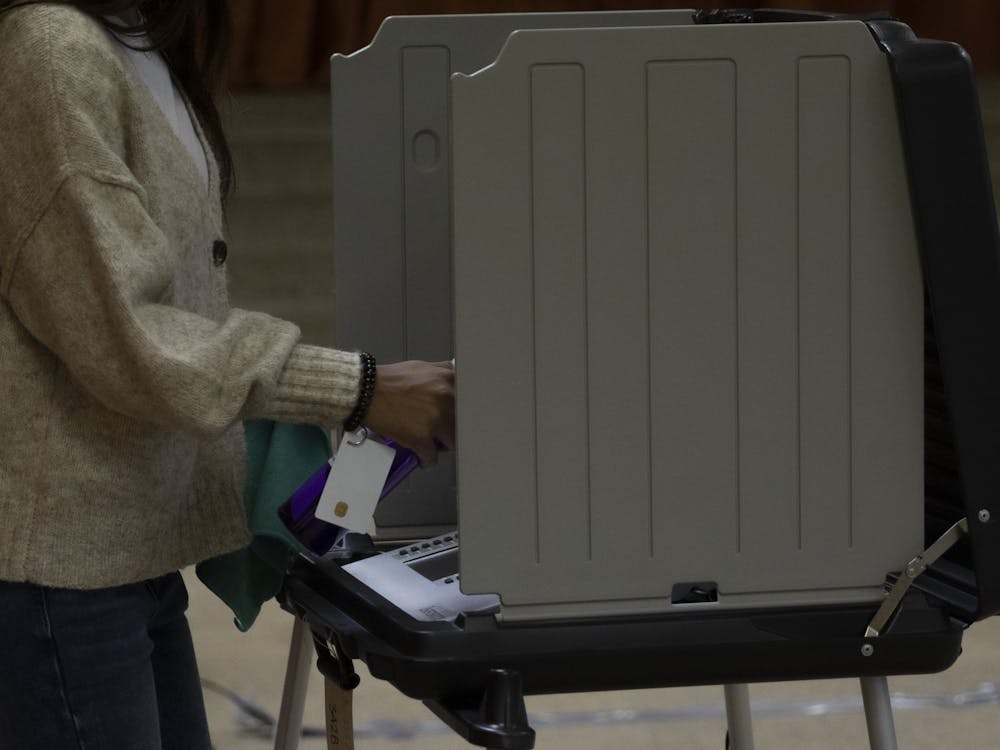 A poll worker cleans off a voting machine Nov. 3, 2020, at First Presbyterian Church. Delaware county had 98 polling locations for voters. Jacob Musselman, DN