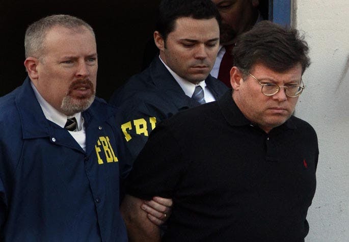 Timothy Durham, 48, right, CEO of National Lampoon Inc., the comedy brand behind "Animal House," and the "Vacation" movie franchise, is taken into custody by FBI Agents at the Federal Building in Westwood, California, in connection with an alleged $200-million Ponzi scheme, Wednesday, March 16, 2011. (Mark Boster/Los Angeles Times/MCT)