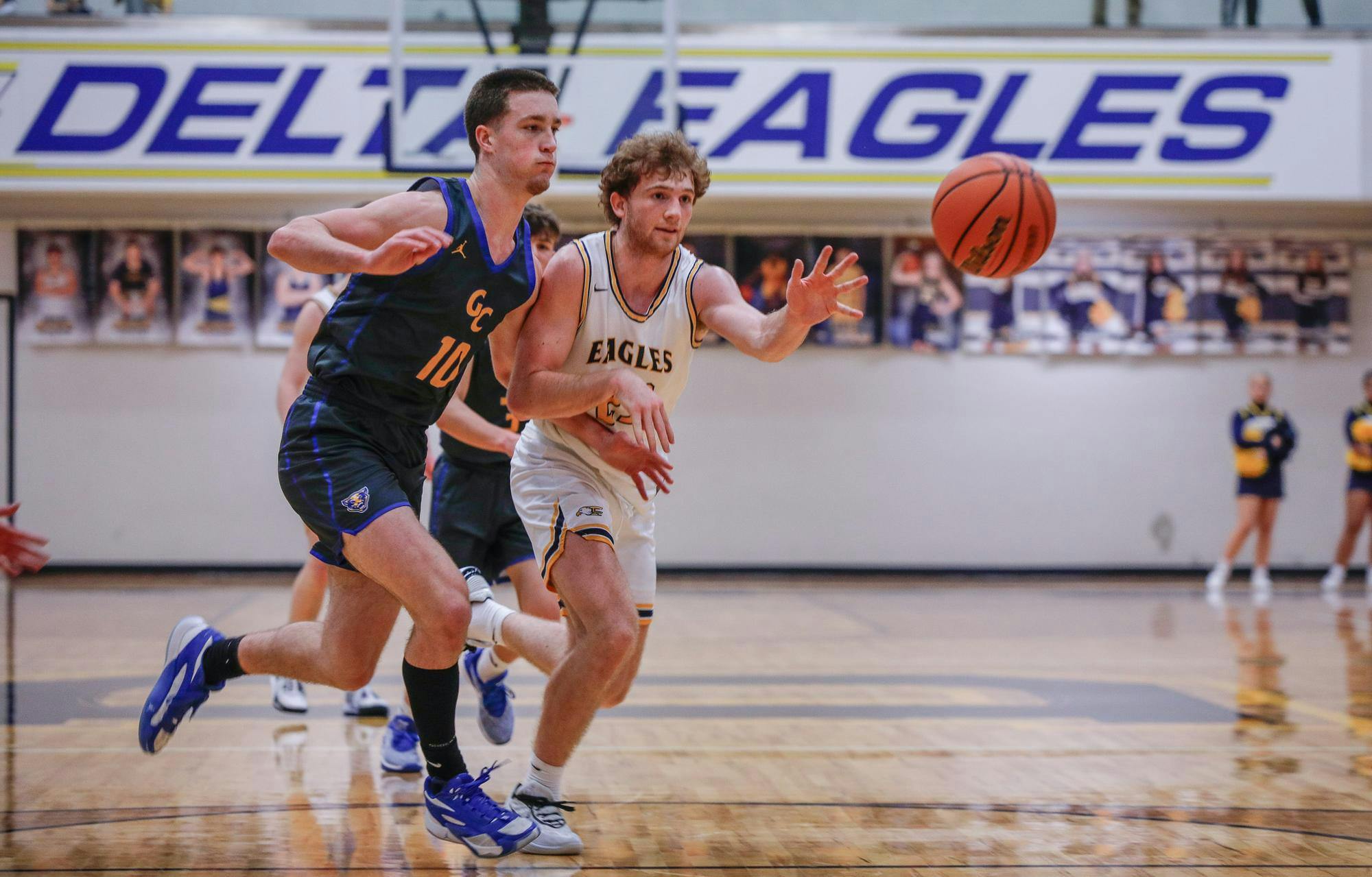 Senior forward Jackson Wors makes a last second pass against Greenfield-Central Feb. 1 at Delta High School. Wors made two three-point shots in the game. Andrew Berger, DN 
