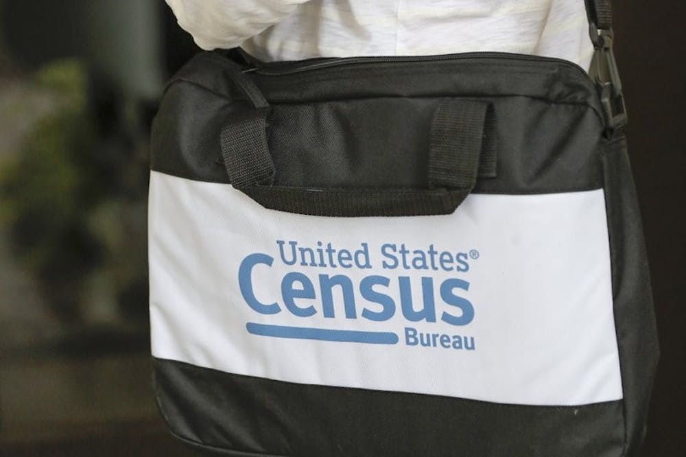 A briefcase of a census taker is seen as she knocks on the door of a residence Tuesday, Aug. 11, 2020, in Winter Park, Fla. A half-million census takers head out en mass this week to knock on the doors of households that haven't yet responded to the 2020 census. (AP Photo/John Raoux)