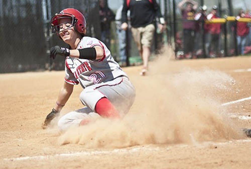 Amanda Carpenter slides home to score the second run for Ball State during the match against Central Michigan on April 22, 2012. Carpenter scored her second career grand slam against Michigan State, helping the team to a 7-2 victory. DN FILE PHOTO JONATHAN MIKSANEK