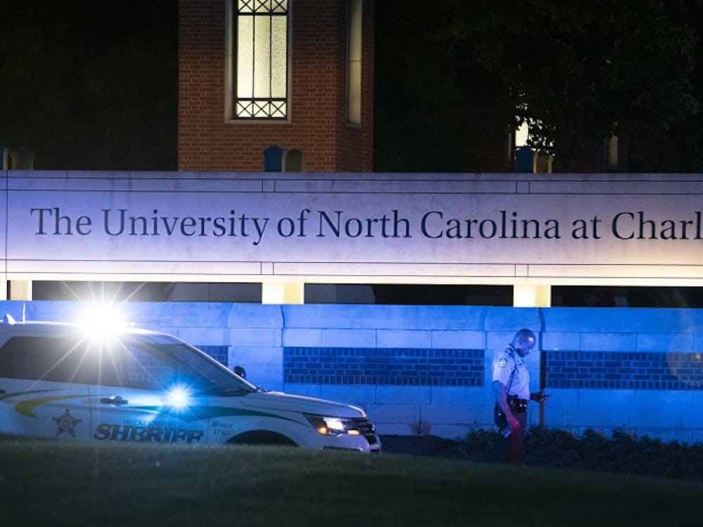 Police secure the main entrance to UNC Charlotte after a shooting at the school that left at least two people dead, Tuesday, April 30, 2019, in Charlotte, N.C. (AP Photo/Jason E. Miczek)