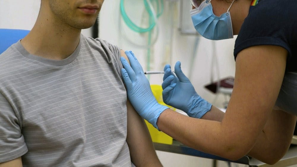 <p>A volunteer is injected with either an experimental COVID-19 vaccine or a comparison shot April 25, 2020, as part of the first human trials in the U.K. to test a potential vaccine, led by Oxford University in England. About 100 research groups around the world are pursuing vaccines against the coronavirus, with nearly a dozen in early stages of human trials or poised to start. <strong>(University of Oxford via AP)</strong></p>