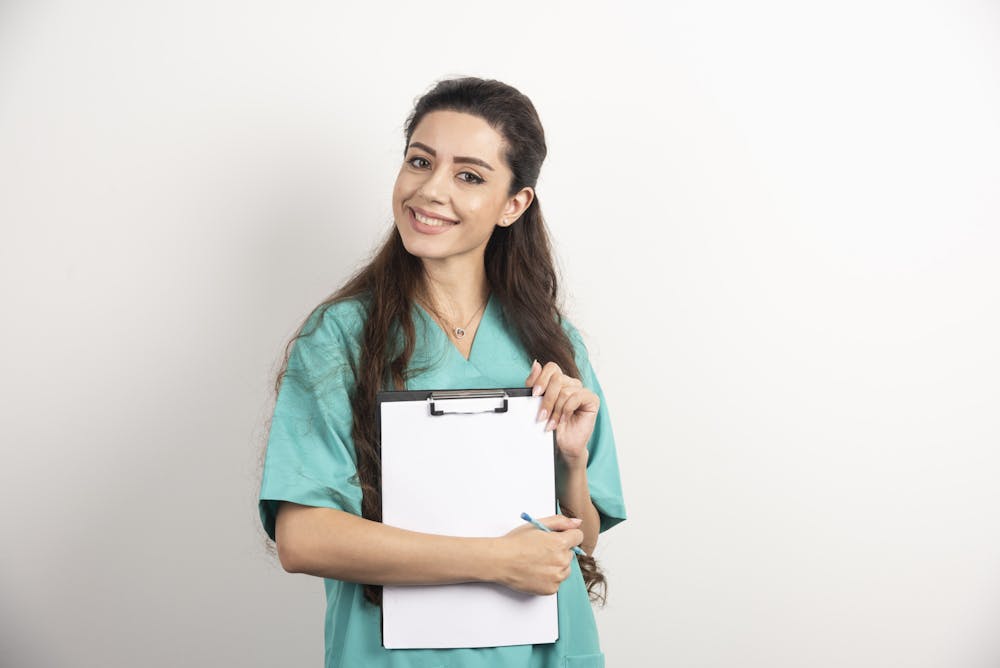 Young female medical employee holding medical records. 