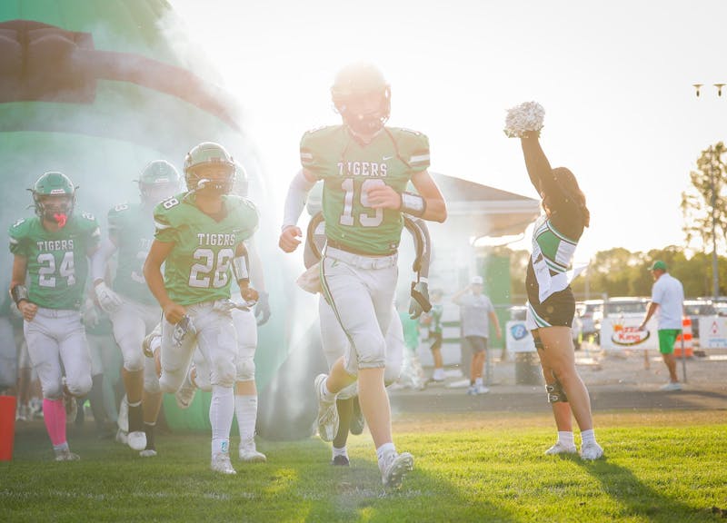 The Yorktown Tigers run out to play Delta High School Sept. 13 at Yorktown High School. Andrew Berger, DN 