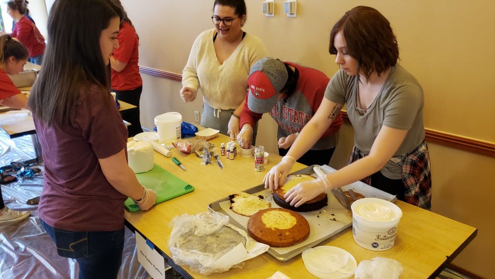 The Cookie Cutters start the construction of their cake at the annual Cake Wars Saturday in Woodworth Complex. Seven teams faced off to create the most creative cake from the theme "Under the Sea." John Lynch, DN