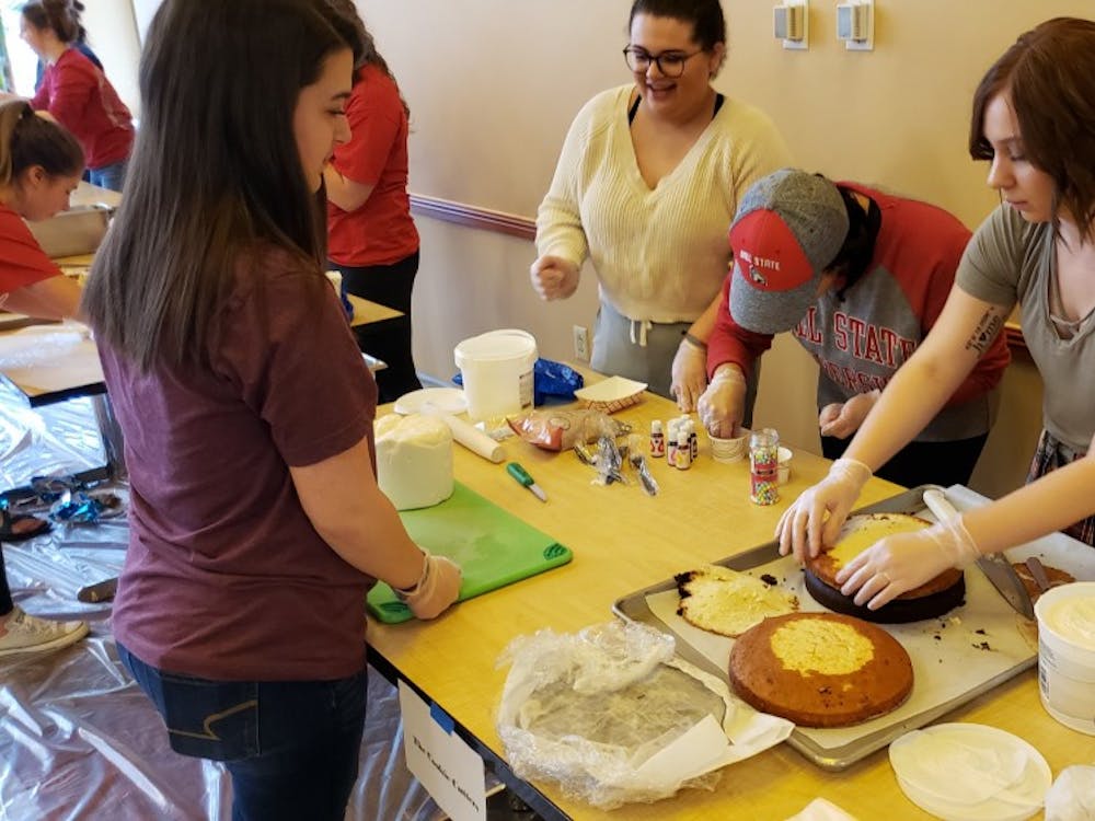 The Cookie Cutters start the construction of their cake at the annual Cake Wars Saturday in Woodworth Complex. Seven teams faced off to create the most creative cake from the theme "Under the Sea." John Lynch, DN